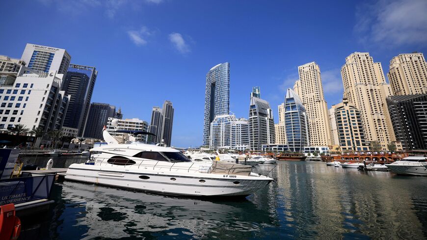 Boats are anchored in the Dubai Creek surrounded by high-rise buildings in the Gult emirate, on February 18, 2023. Home to towering skyscrapers and ultra-luxury villas, Dubai saw record real estate transactions in 2022, largely due to an influx of wealthy investors.